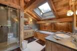 This luxurious bathroom boasts a rustic, yet elegant design, perfect for a relaxing retreat.