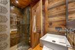 This rustic bathroom features a stunning wooden design, creating a warm and inviting atmosphere.