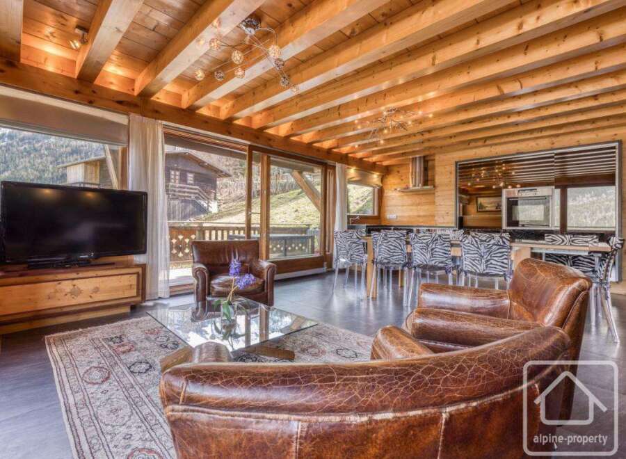 Experience luxury living in this stunning property, featuring a beautifully designed interior with exposed wooden beams and elegant furnishings.