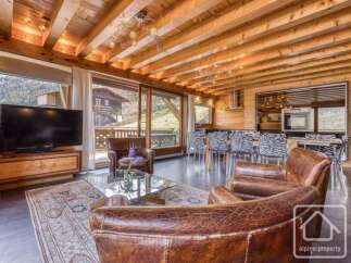 Experience luxury living in this stunning property, featuring a beautifully designed interior with exposed wooden beams and elegant furnishings.