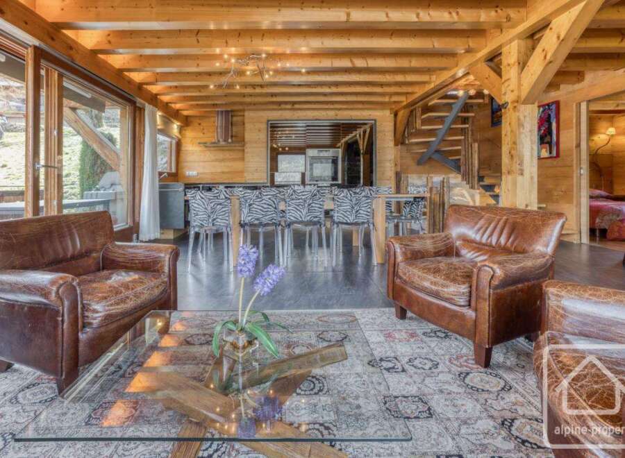 Experience luxury living in this stunning property featuring a cozy living room with comfortable leather armchairs.