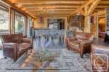 Experience luxury living in this stunning property featuring a cozy living room with comfortable leather armchairs.