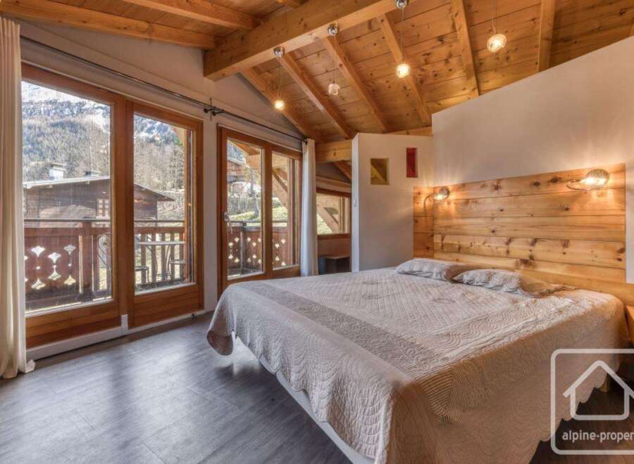 Experience the charm of this cozy bedroom, featuring a stunning wooden ceiling and a comfortable bed.