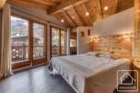 Experience the charm of this cozy bedroom, featuring a stunning wooden ceiling and a comfortable bed.