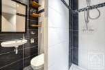 This modern bathroom features a sleek design with contrasting black and white tiles.