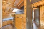 This cozy cabin bedroom features a unique bunk bed design, perfect for maximizing space.