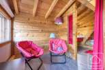 Discover the charm of this cozy property, featuring a unique wooden interior and inviting seating areas.