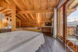 Experience the charm of this cozy alpine property, featuring a warm wooden interior and stunning mountain views.