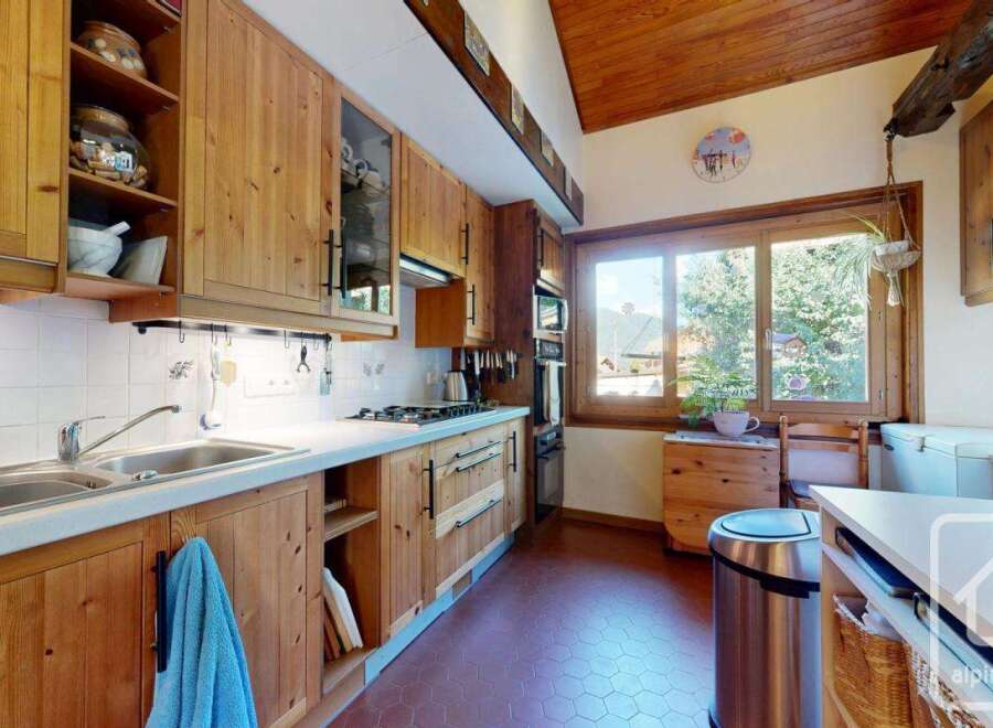 Discover the charm of this rustic kitchen, featuring warm wooden cabinetry and a cozy atmosphere.
