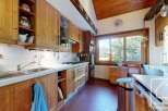 Discover the charm of this rustic kitchen, featuring warm wooden cabinetry and a cozy atmosphere.