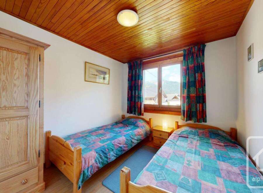 This charming bedroom features two single beds, perfect for guests or family.
