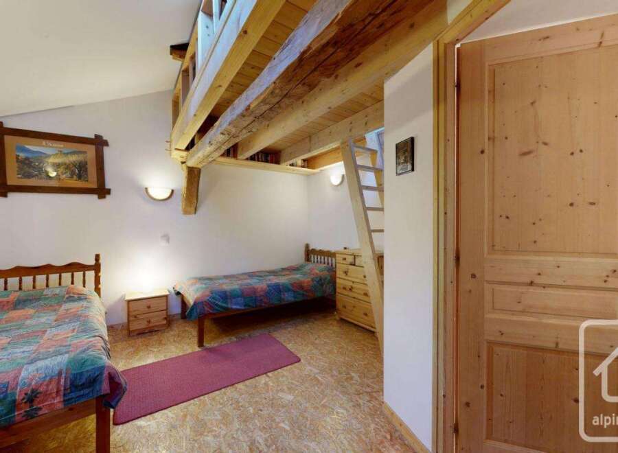 Discover the charm of this cozy property, featuring a unique loft space and rustic wooden beams.