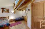 Discover the charm of this cozy property, featuring a unique loft space and rustic wooden beams.