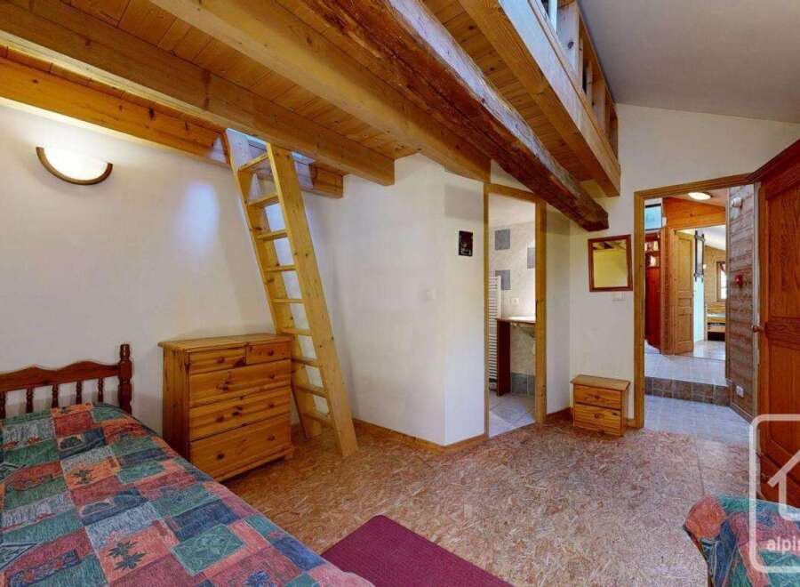 Discover the charm of this cozy property, featuring a unique loft space and rustic wooden beams.