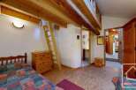 Discover the charm of this cozy property, featuring a unique loft space and rustic wooden beams.