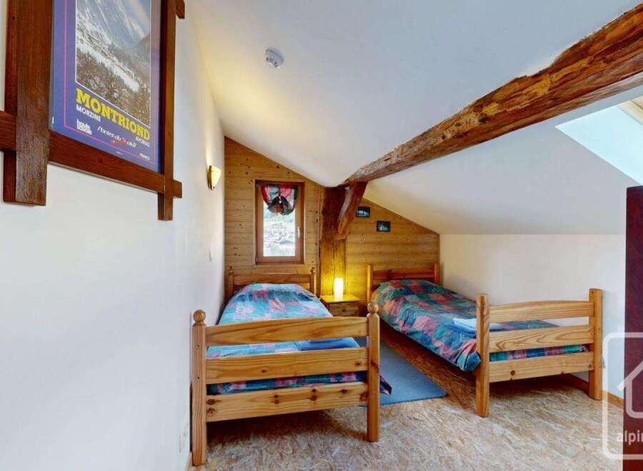 Discover this charming attic bedroom, perfect for a cozy retreat.