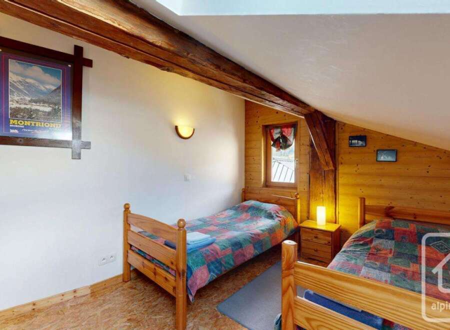 Discover this charming bedroom featuring a cozy atmosphere and rustic wooden accents.