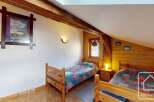 Discover this charming bedroom featuring a cozy atmosphere and rustic wooden accents.