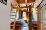 Discover a cozy bedroom featuring two single beds, perfect for a family or group of friends.