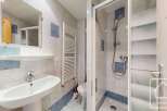 This well-maintained bathroom features a modern sink, a convenient shower, and a stylish heated towel rack.