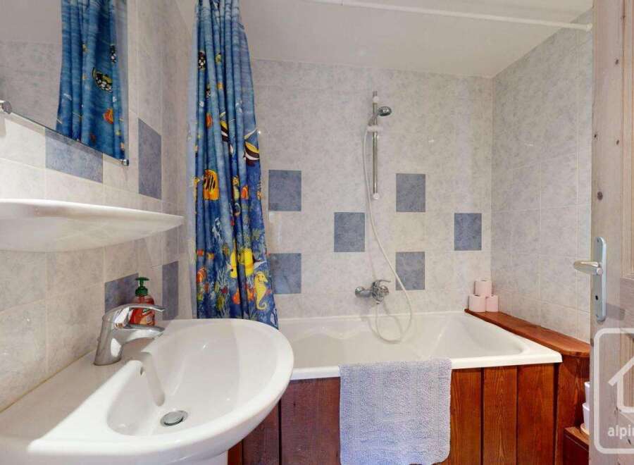 This charming bathroom features a bright and inviting space with a combination of functionality and style.