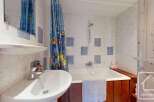 This charming bathroom features a bright and inviting space with a combination of functionality and style.