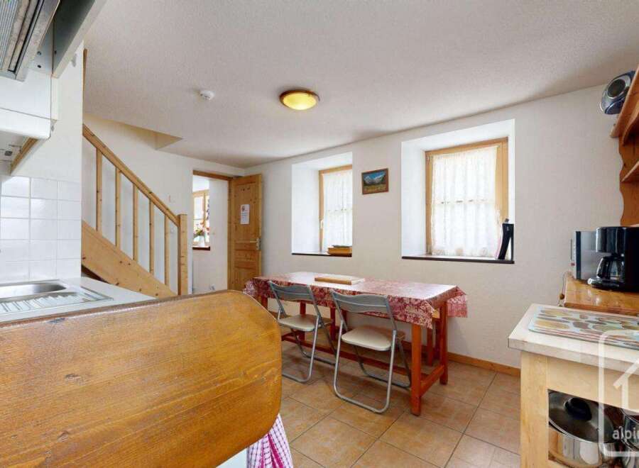Discover the charm of this cozy property, featuring a well-equipped kitchen and a dining area perfect for intimate gatherings.