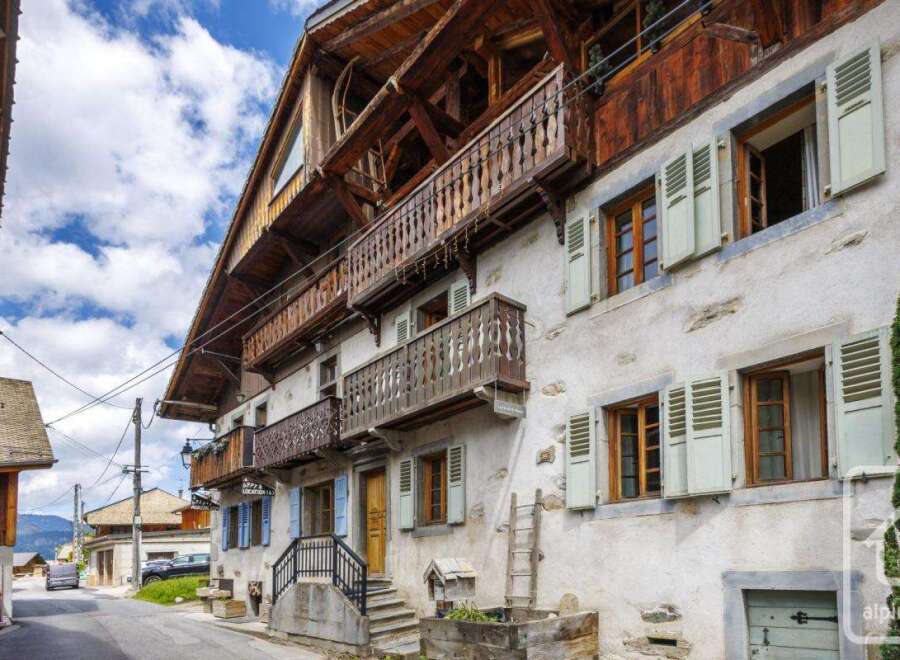 Discover the charm of this stunning property, featuring traditional wooden balconies and shutters, exuding a warm and inviting ambiance.