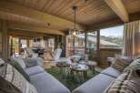 Experience luxury living in this stunning chalet, featuring a cozy living room with a plush sofa and a unique coffee table.
