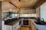 This stunning kitchen boasts a modern design with a rustic touch, perfect for any home.