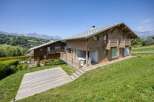 Discover a stunning chalet nestled in a picturesque mountain setting.