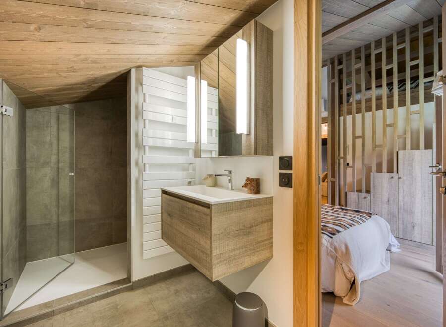 This stunning bathroom features a modern design with a wooden ceiling and a sleek vanity.