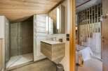 This stunning bathroom features a modern design with a wooden ceiling and a sleek vanity.