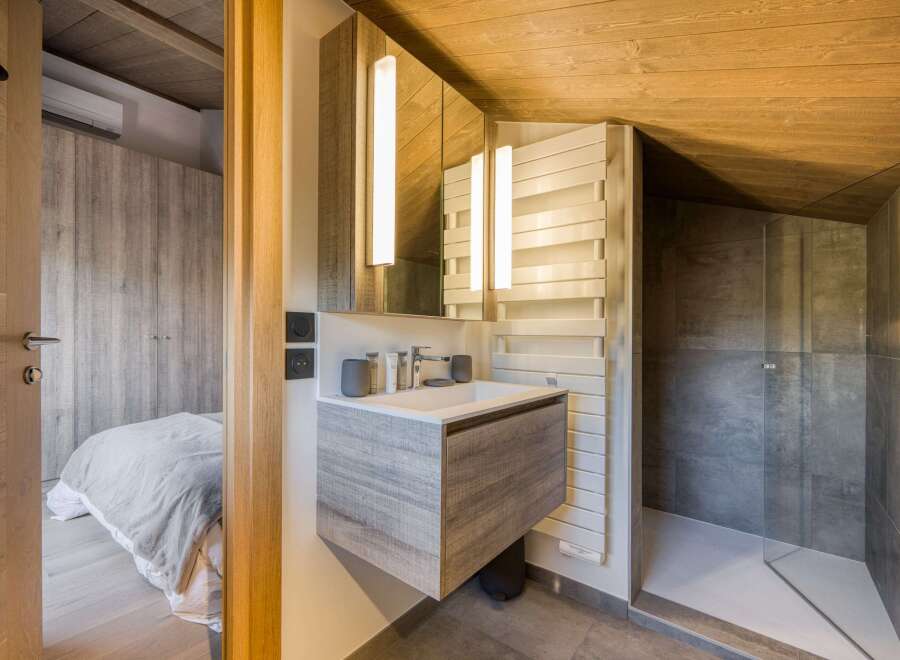 This modern bathroom features a sleek, floating vanity with a minimalist design.