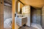 This modern bathroom features a sleek, floating vanity with a minimalist design.