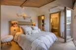 Experience luxury in this stunning bedroom featuring a cozy bed with plush pillows and a stylish headboard.