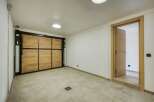 This spacious interior features a unique wooden garage door, adding a touch of rustic charm.
