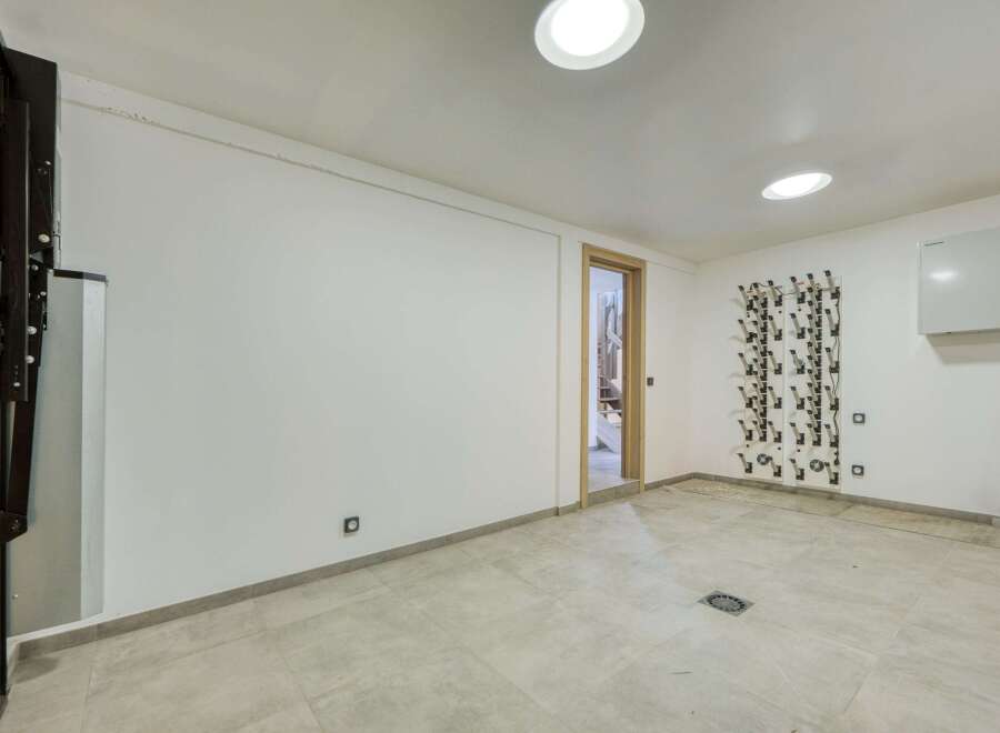 This modern space features a clean, minimalist design with bright white walls and recessed lighting.