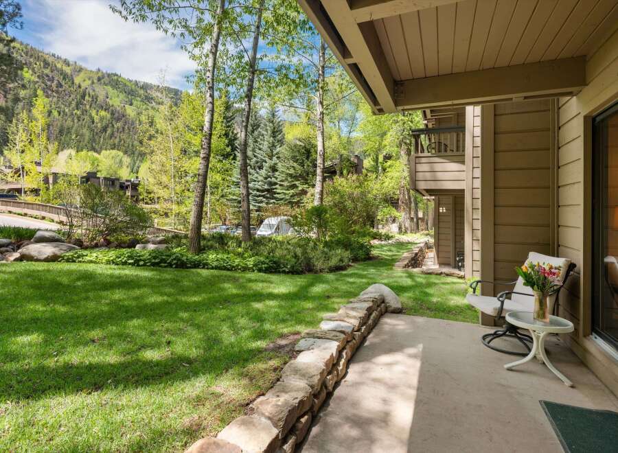 Enjoy the tranquility of this stunning property with a lush green lawn and a charming stone wall.