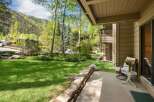 Enjoy the tranquility of this stunning property with a lush green lawn and a charming stone wall.