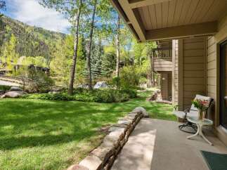 Enjoy the tranquility of this stunning property with a lush green lawn and a charming stone wall.