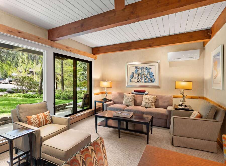 Step into this inviting living space, featuring a cozy sofa and stylish armchairs, perfect for relaxation.