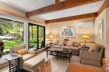 Step into this inviting living space, featuring a cozy sofa and stylish armchairs, perfect for relaxation.