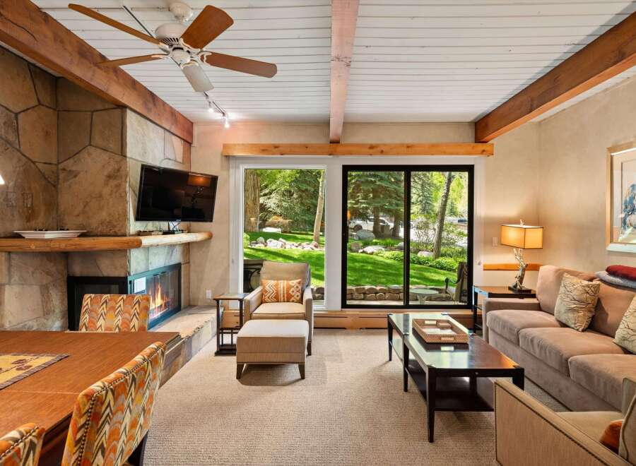 This stunning property boasts a cozy living room with a stone fireplace, perfect for relaxing evenings.