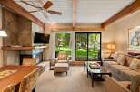 This stunning property boasts a cozy living room with a stone fireplace, perfect for relaxing evenings.