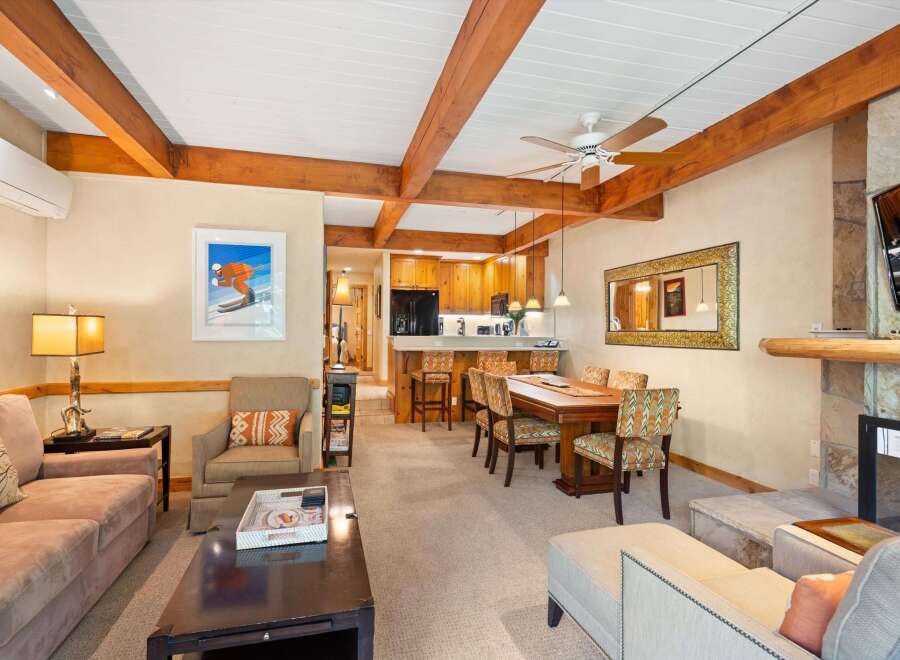 This stunning property boasts a cozy living area with a fireplace and a spacious dining area, perfect for entertaining.