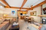 This stunning property boasts a cozy living area with a fireplace and a spacious dining area, perfect for entertaining.