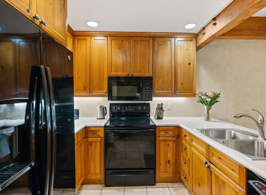 This stunning kitchen boasts beautiful wooden cabinetry and modern appliances.