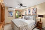 This cozy bedroom features a comfortable bed with a stylish headboard, perfect for a relaxing retreat.