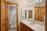 This luxurious bathroom features a spacious vanity with a sleek countertop and a stylish sink.